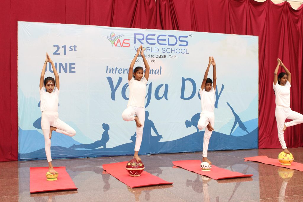 Young students performing yoga asanas with concentration and enthusiasm.